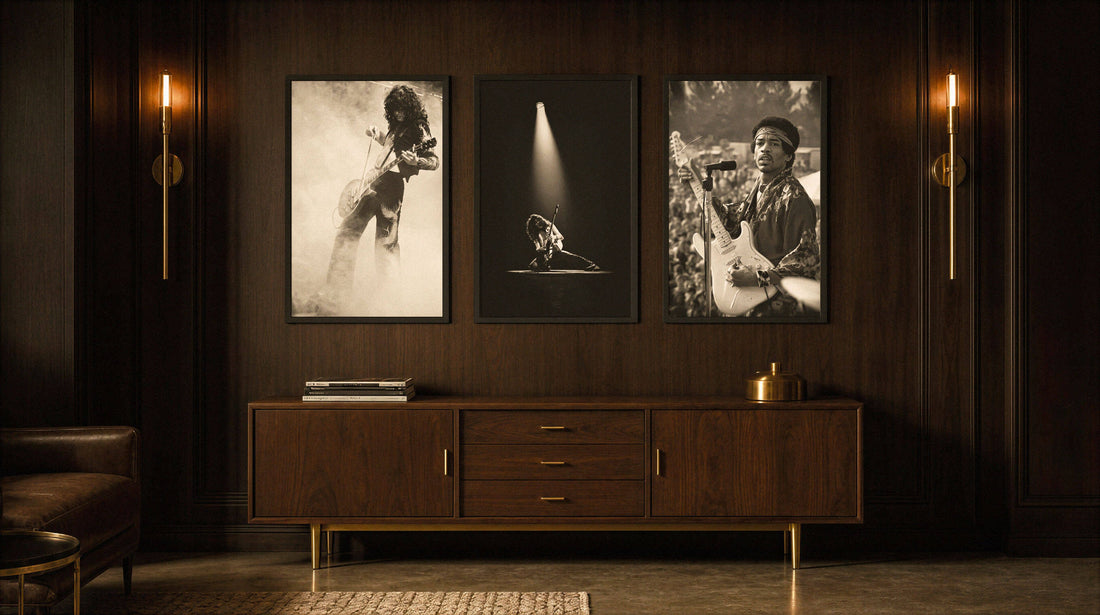 Three black and white music posters hung in a row above a walnut credenza