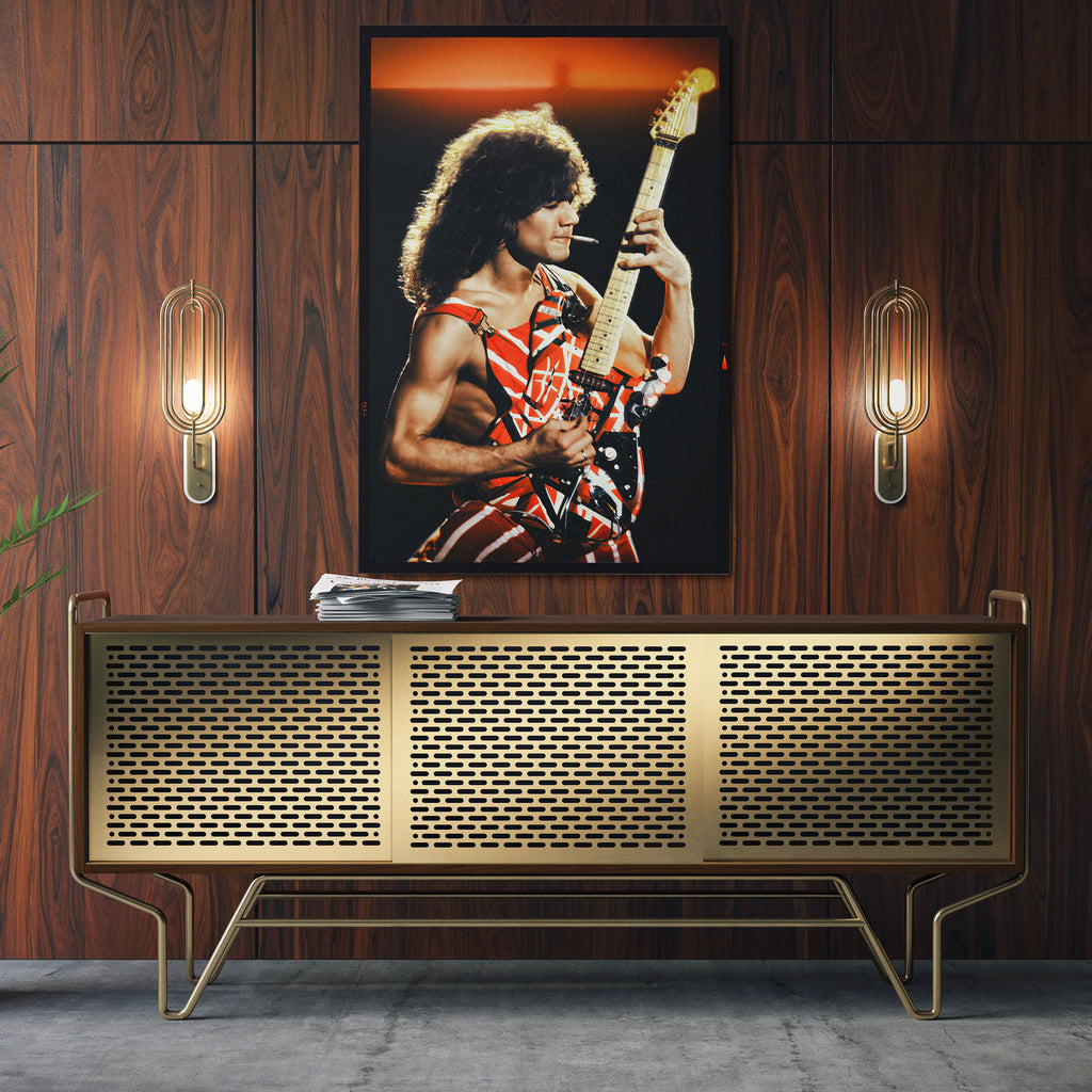Sleek aluminum metal print of rock icon Eddie Van Halen displayed over a luxury mid-century modern credenza setup.