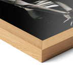 Corner close-up highlighting the natural oak finish of the framed Amy Winehouse 2007 black and white poster.