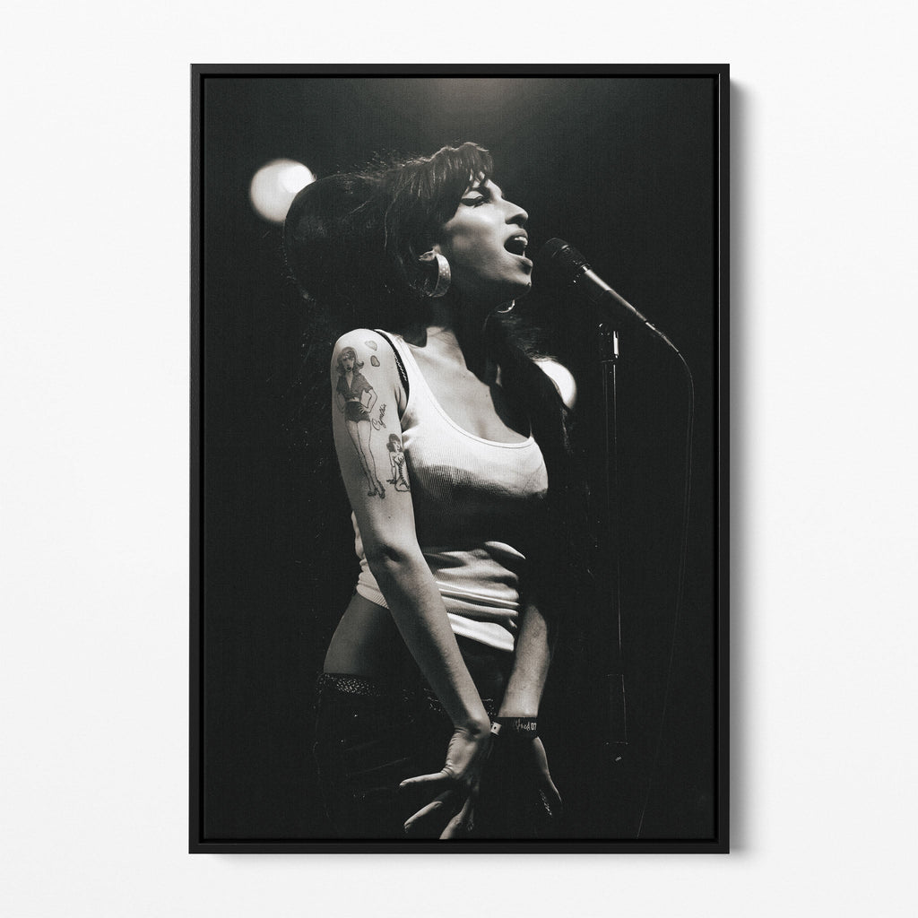 Front view of the Amy Winehouse 2007 black and white canvas in a sleek black floating frame.