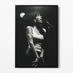 Front view of the Amy Winehouse 2007 black and white canvas in a sleek black floating frame.