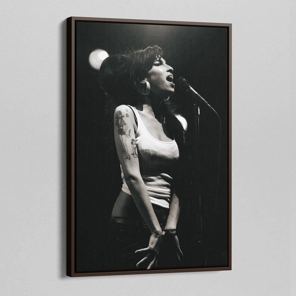Angled view of the Amy Winehouse 2007 black and white canvas in a sophisticated dark walnut floating frame.