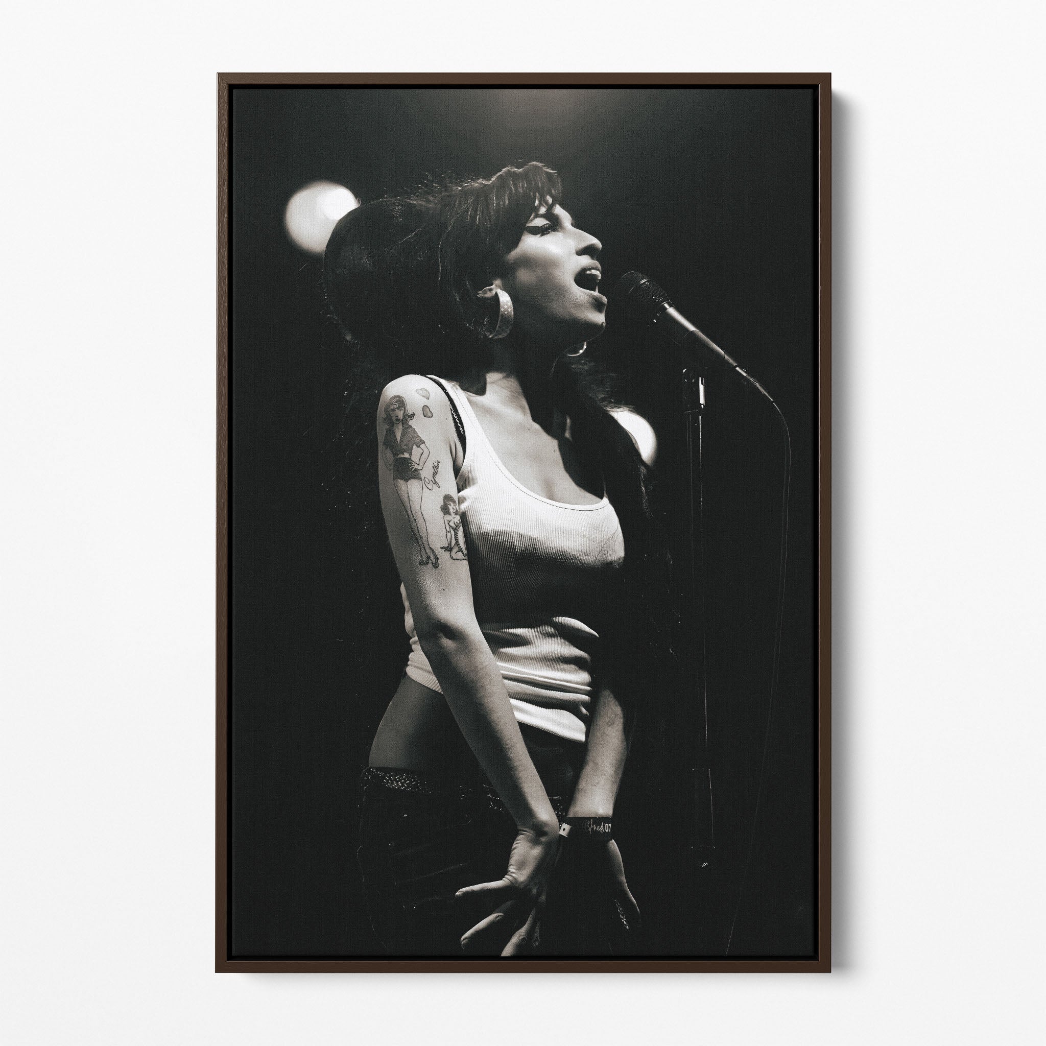 Front display of the Amy Winehouse 2007 black and white canvas in a premium dark walnut floating frame.