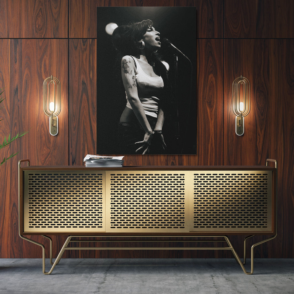 Sleek aluminum black and white metal print of Amy Winehouse displayed over a mid-century modern credenza.