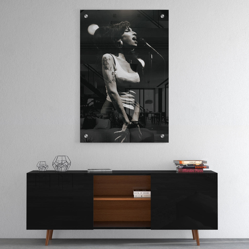 High-gloss acrylic glass black and white print of Amy Winehouse displayed above a contemporary console.