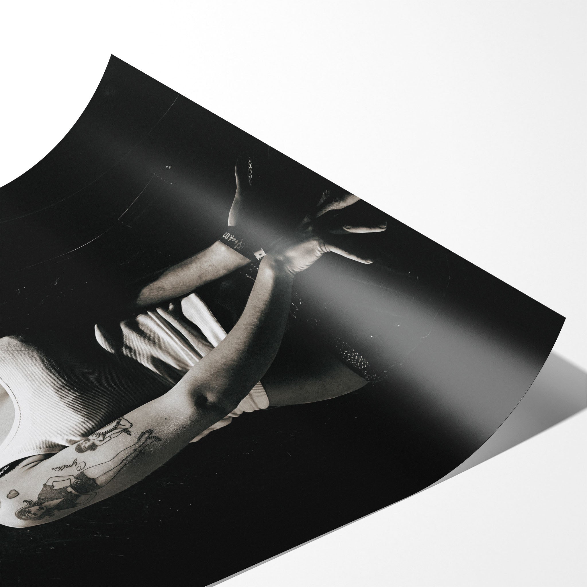 Angled close-up of the unframed premium matte black and white Amy Winehouse 2007 Hultsfred poster print.