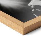 Corner close-up highlighting the natural oak finish of the framed Amy Winehouse 2007 black and white poster.