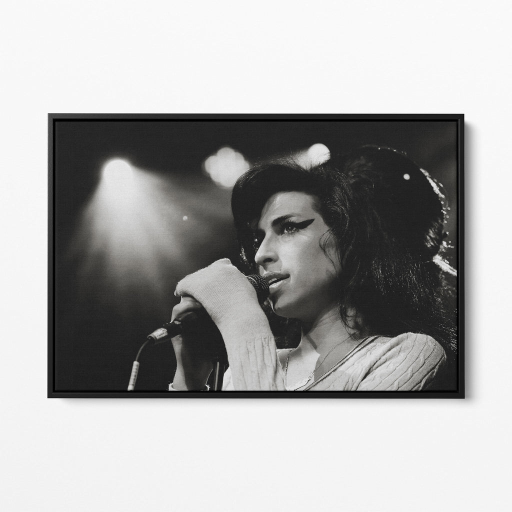Front view of the Amy Winehouse 2007 black and white canvas in a sleek black floating frame.