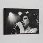 Angled view of the Amy Winehouse 2007 black and white canvas in a sophisticated dark walnut floating frame.