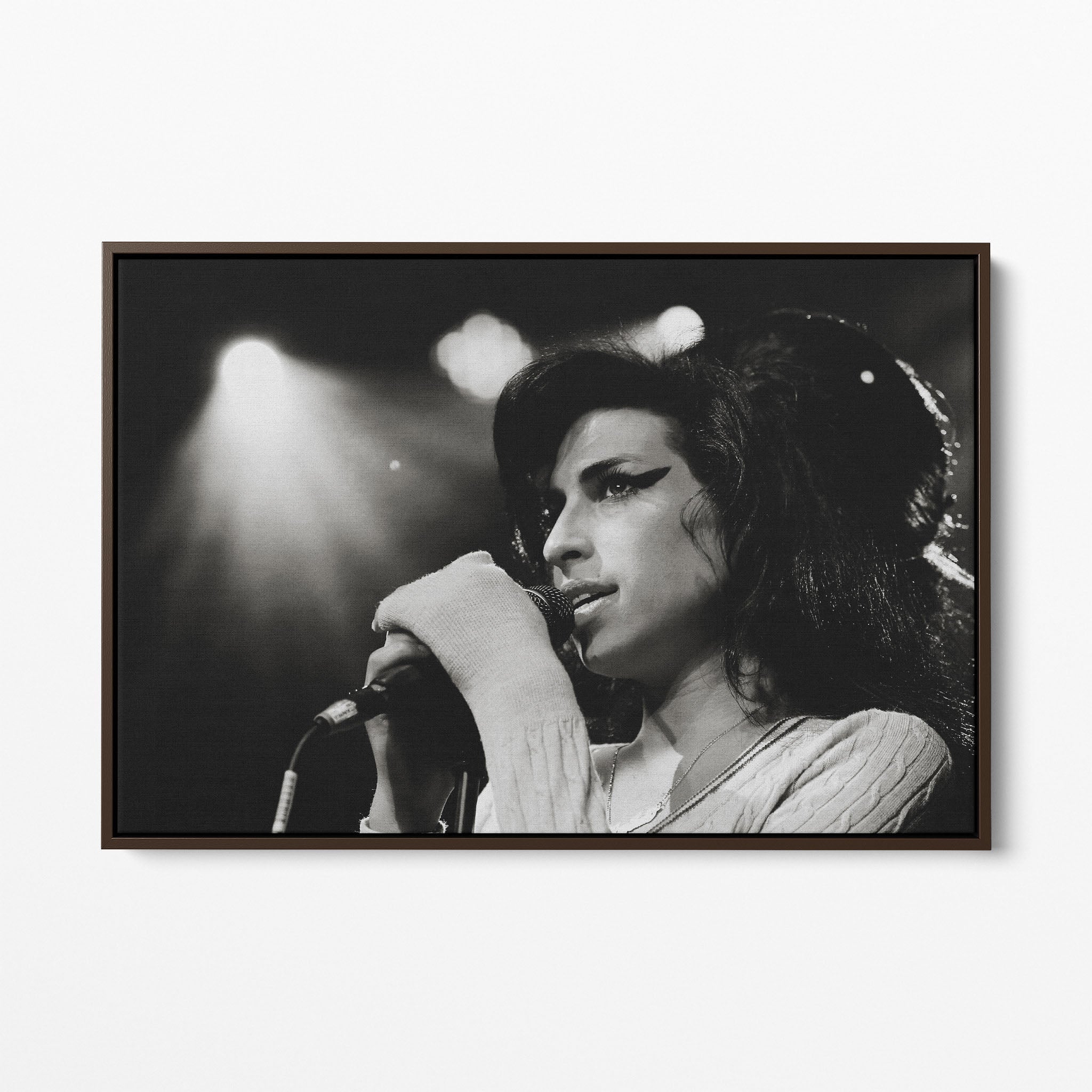 Front display of the Amy Winehouse 2007 black and white canvas in a premium dark walnut floating frame.