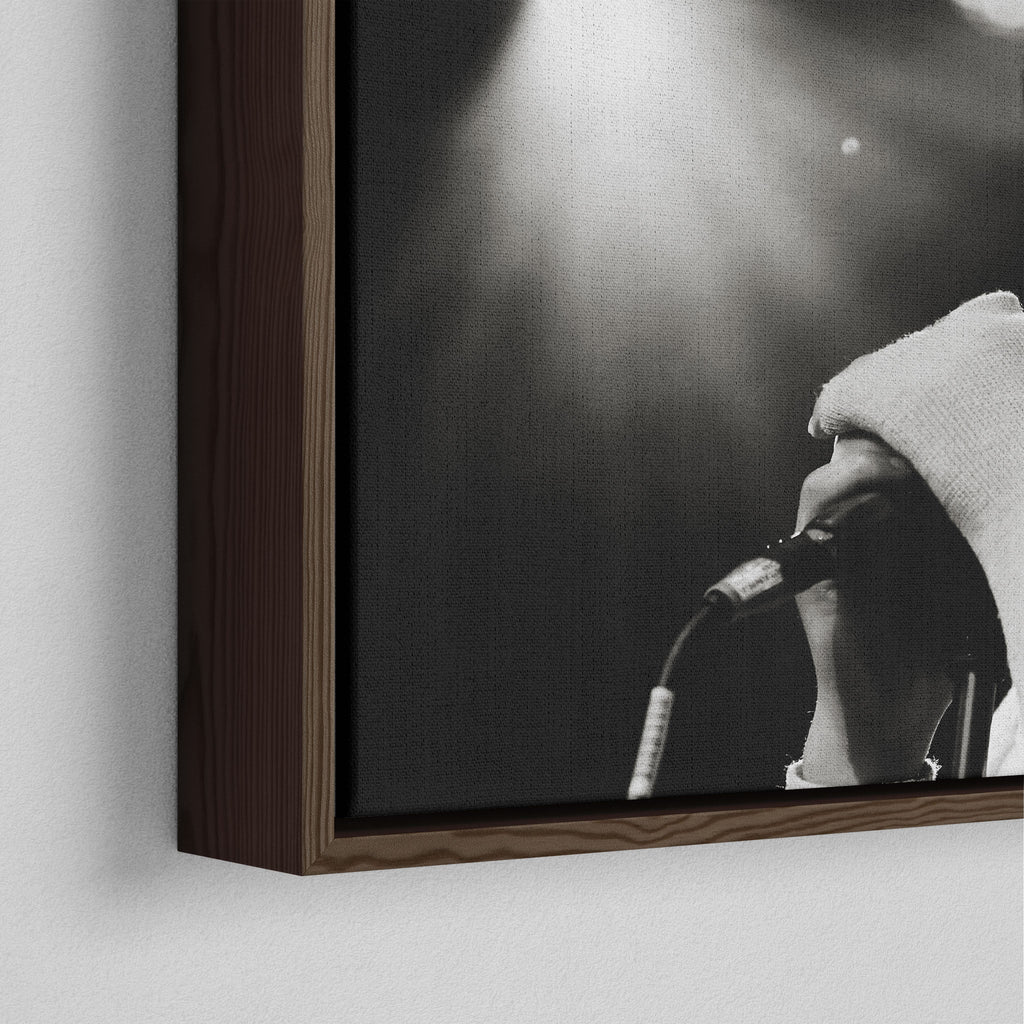 Corner close-up showing the rich grain and joinery of the dark walnut floating canvas frame.
