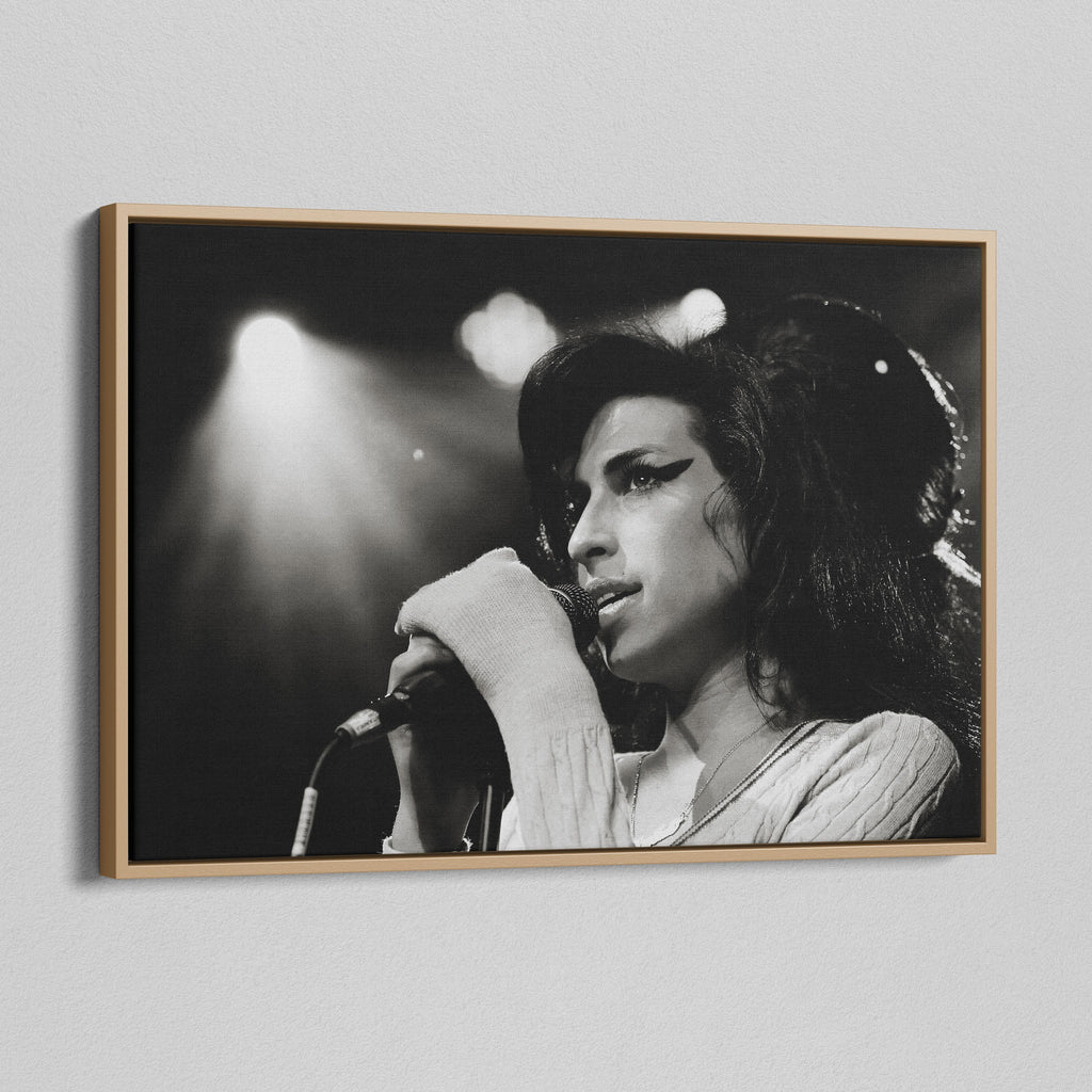 Angled view of the black and white canvas in a modern natural oak wood floating frame.
