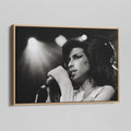 Angled view of the black and white canvas in a modern natural oak wood floating frame.
