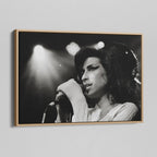 Angled view of the black and white canvas in a modern natural oak wood floating frame.