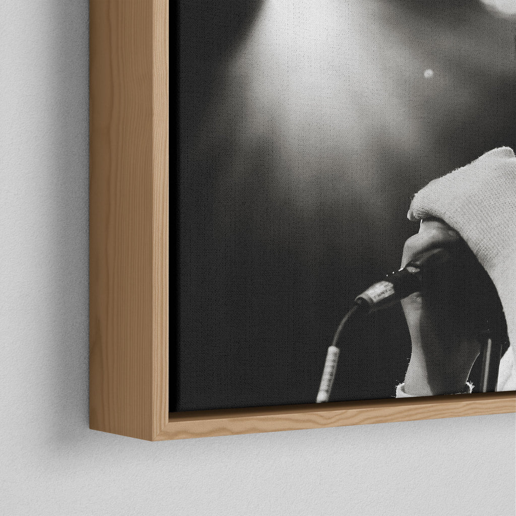 Corner close-up of the floating gap and grain texture of the natural wood canvas frame.
