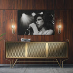 Sleek aluminum black and white metal print of Amy Winehouse displayed over a mid-century modern credenza.