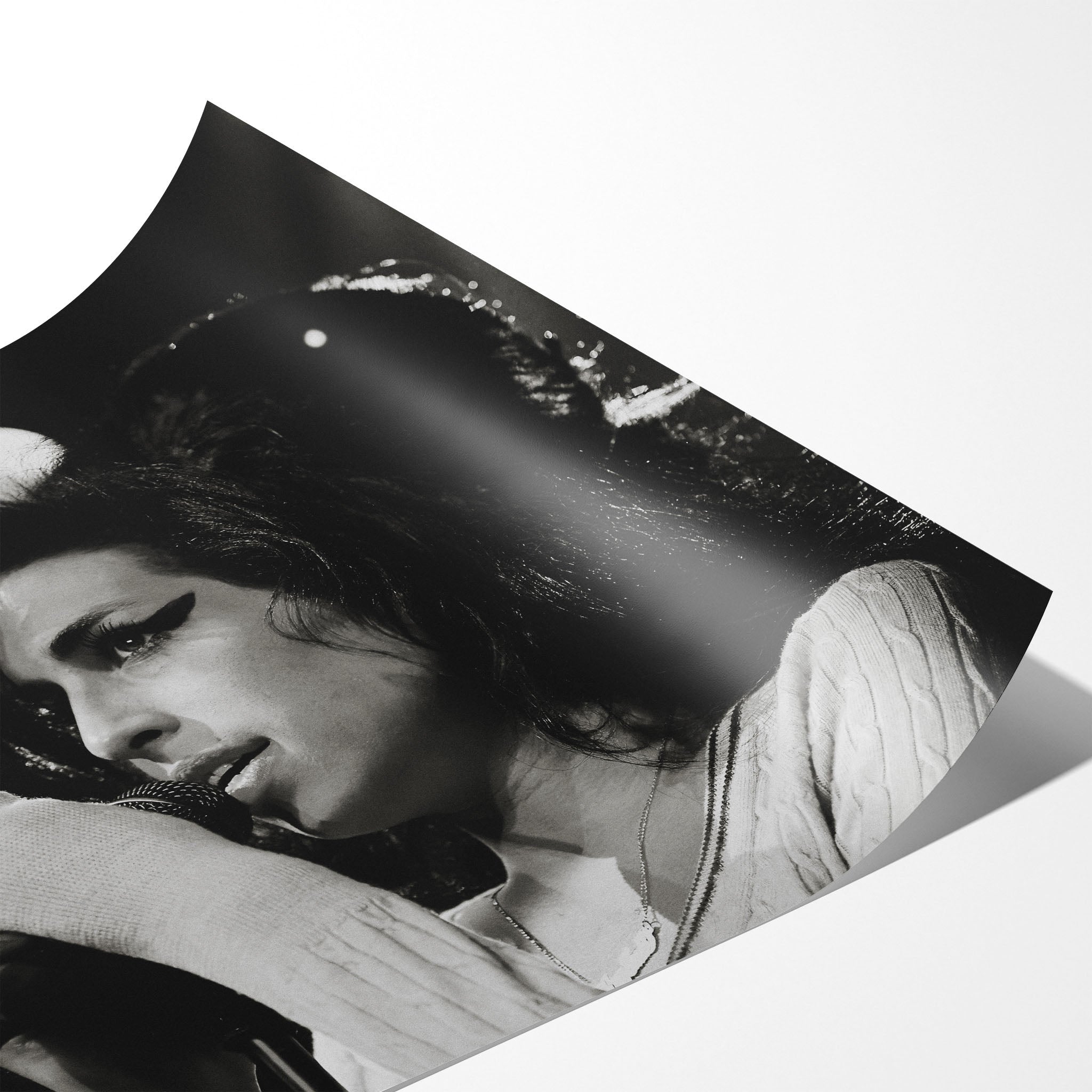 Angled close-up of the unframed premium matte black and white Amy Winehouse 2007 Zurich poster print.