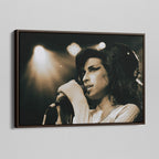 Angled view of the Amy Winehouse 2007 color canvas in a sophisticated dark walnut floating frame.