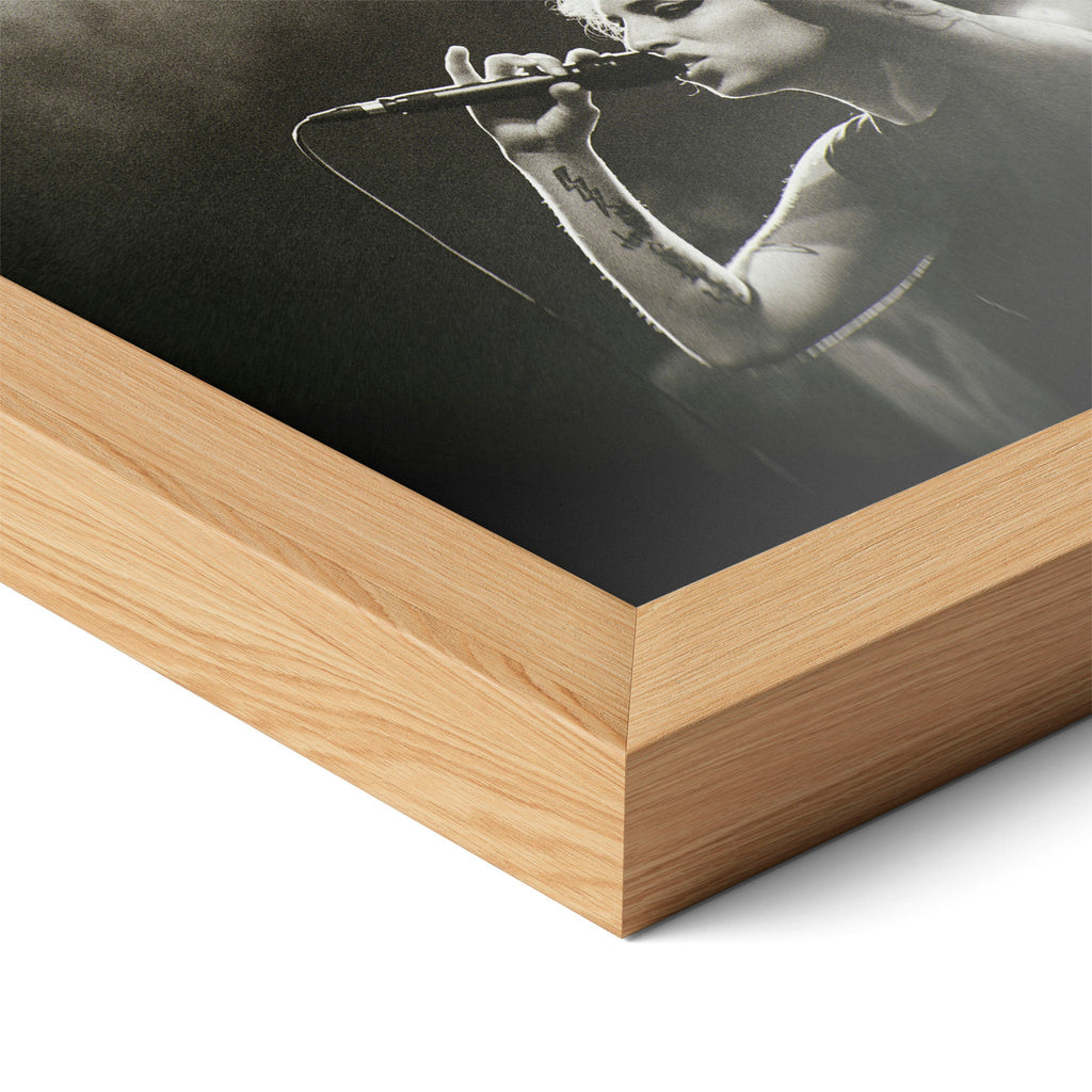 Corner close-up highlighting the natural oak finish of the framed Amy Winehouse black and white poster.