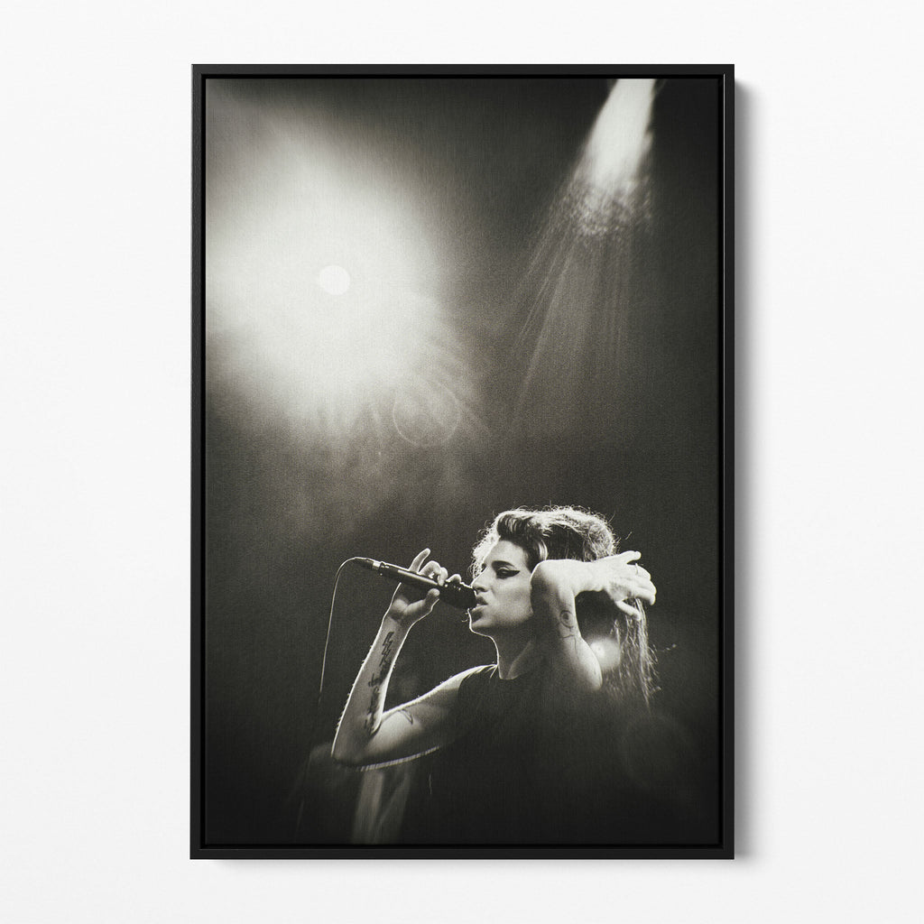 Front view of the Amy Winehouse black and white canvas in a sleek black floating frame.