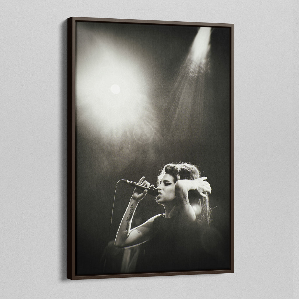 Angled view of the Amy Winehouse black and white canvas in a sophisticated dark walnut floating frame.