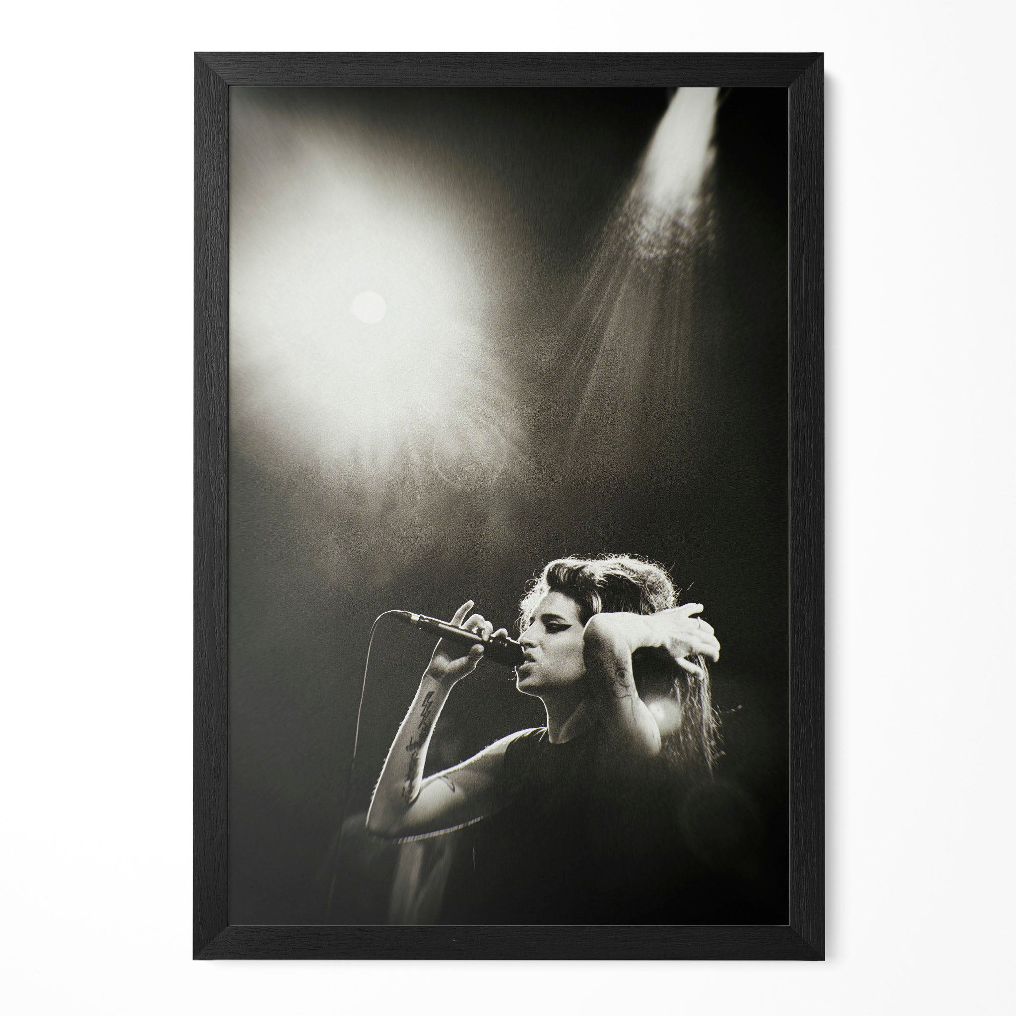 Amy Winehouse Back to Black era black and white live concert poster in a premium classic black wooden frame by POSTEREVER.