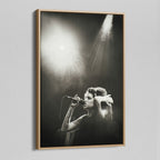Angled view of the black and white canvas in a modern natural oak wood floating frame.