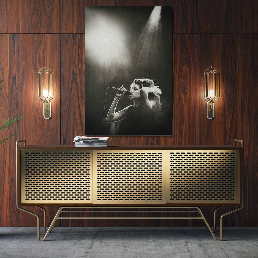 Sleek aluminum black and white metal print of Amy Winehouse displayed over a mid-century modern credenza.