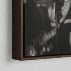 Corner close-up showing the rich grain and joinery of the dark walnut floating canvas frame.
