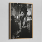 Angled view of the black and white canvas in a modern natural oak wood floating frame.