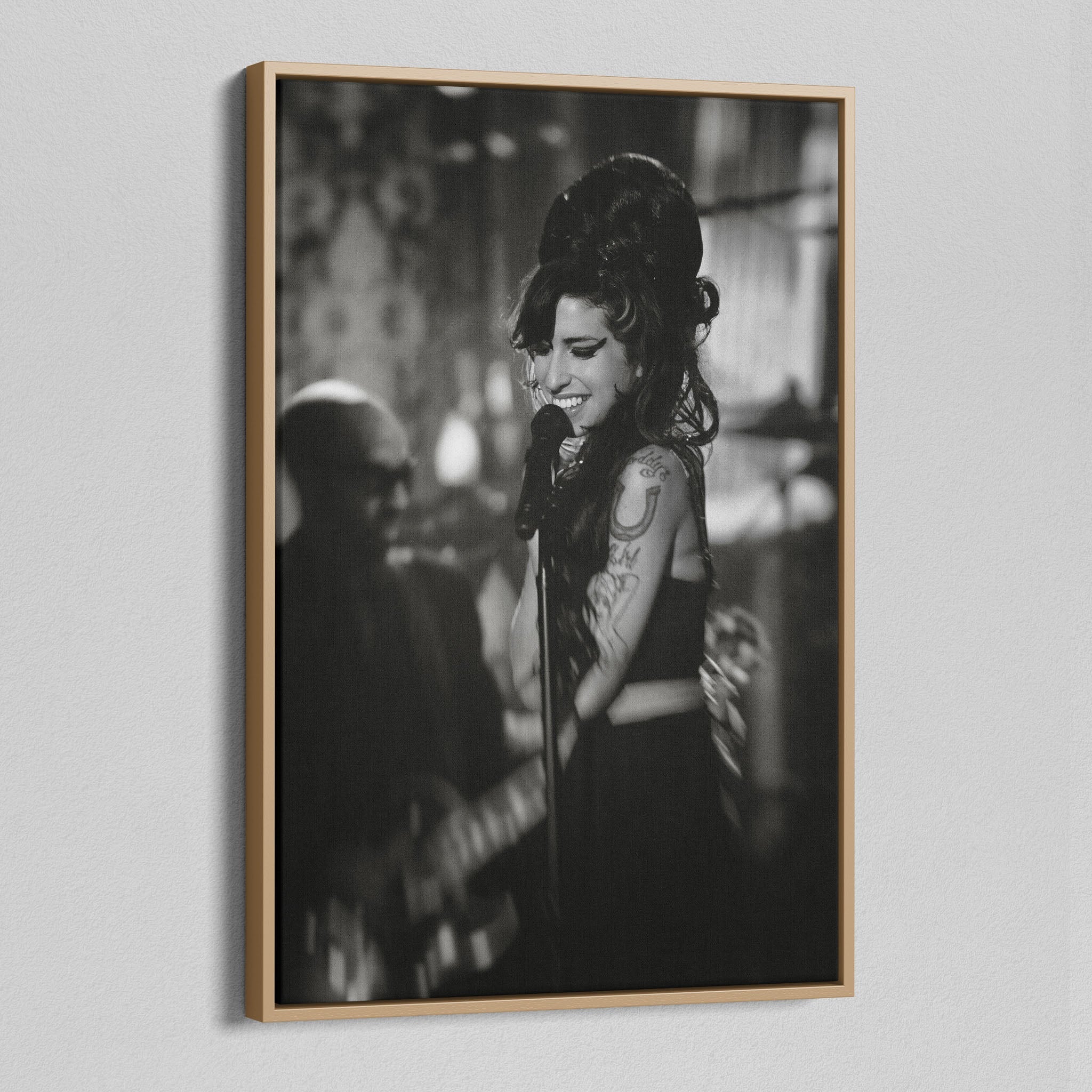 Angled view of the black and white canvas in a modern natural oak wood floating frame.