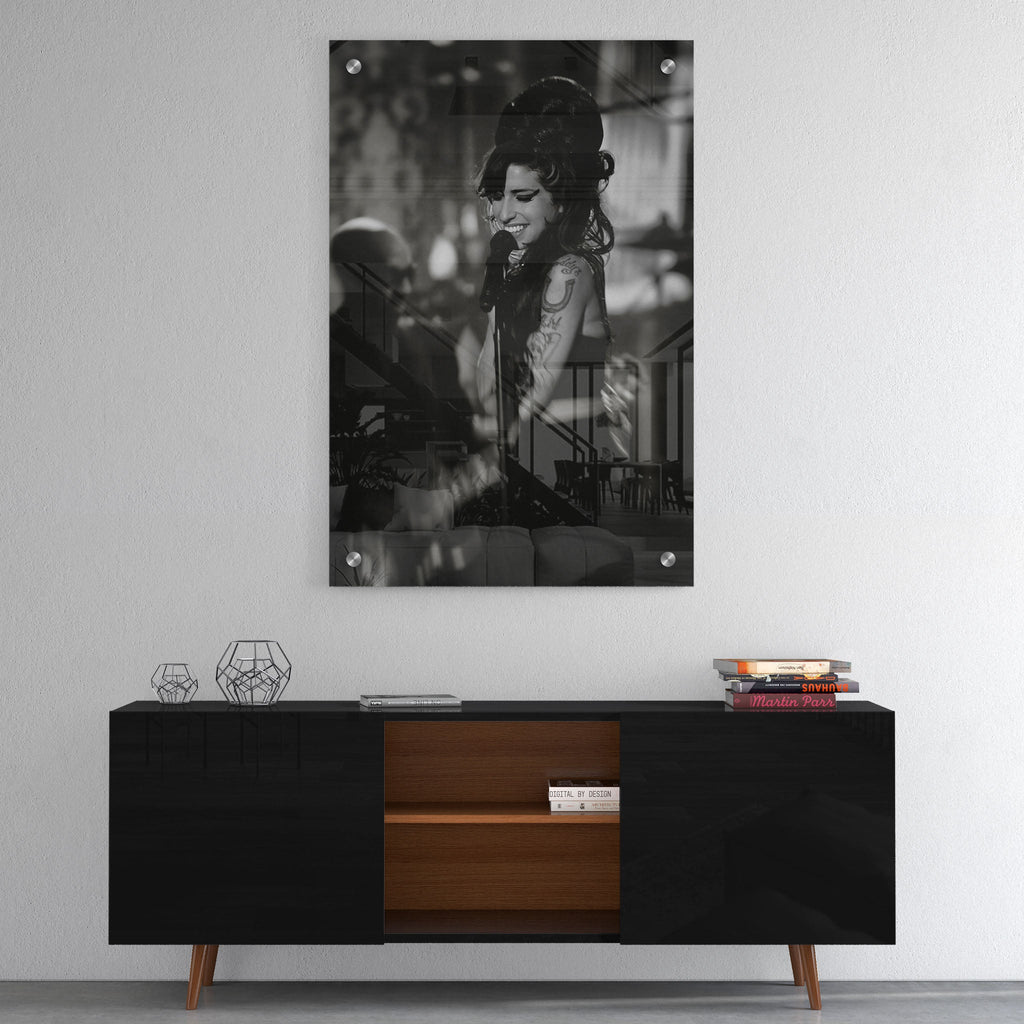 High-gloss acrylic glass black and white print of Amy Winehouse displayed above a contemporary console.