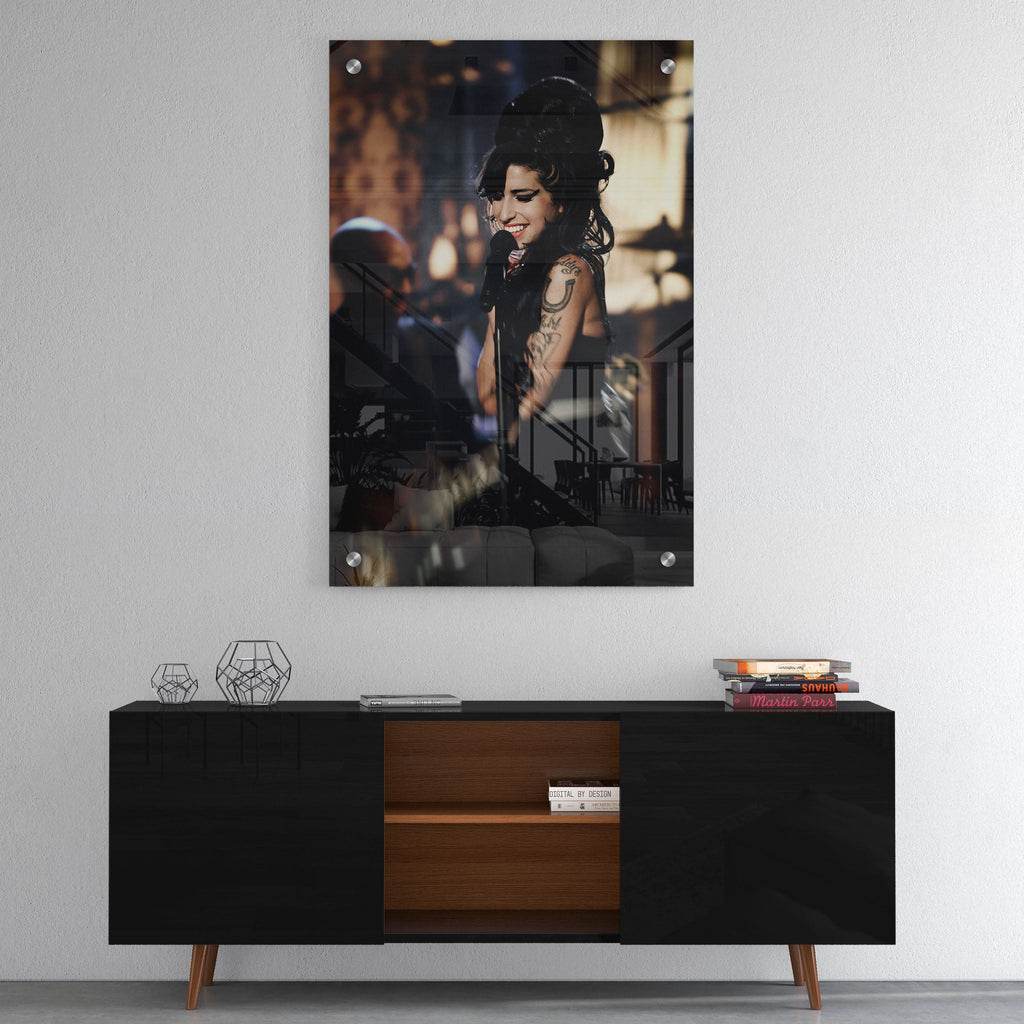High-gloss acrylic glass color print of Amy Winehouse displayed above a contemporary console.