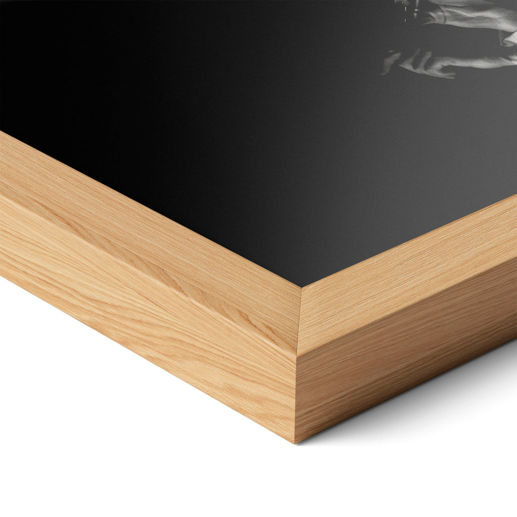 Corner close-up highlighting the natural oak finish of the framed David Bowie 1976 black and white poster.