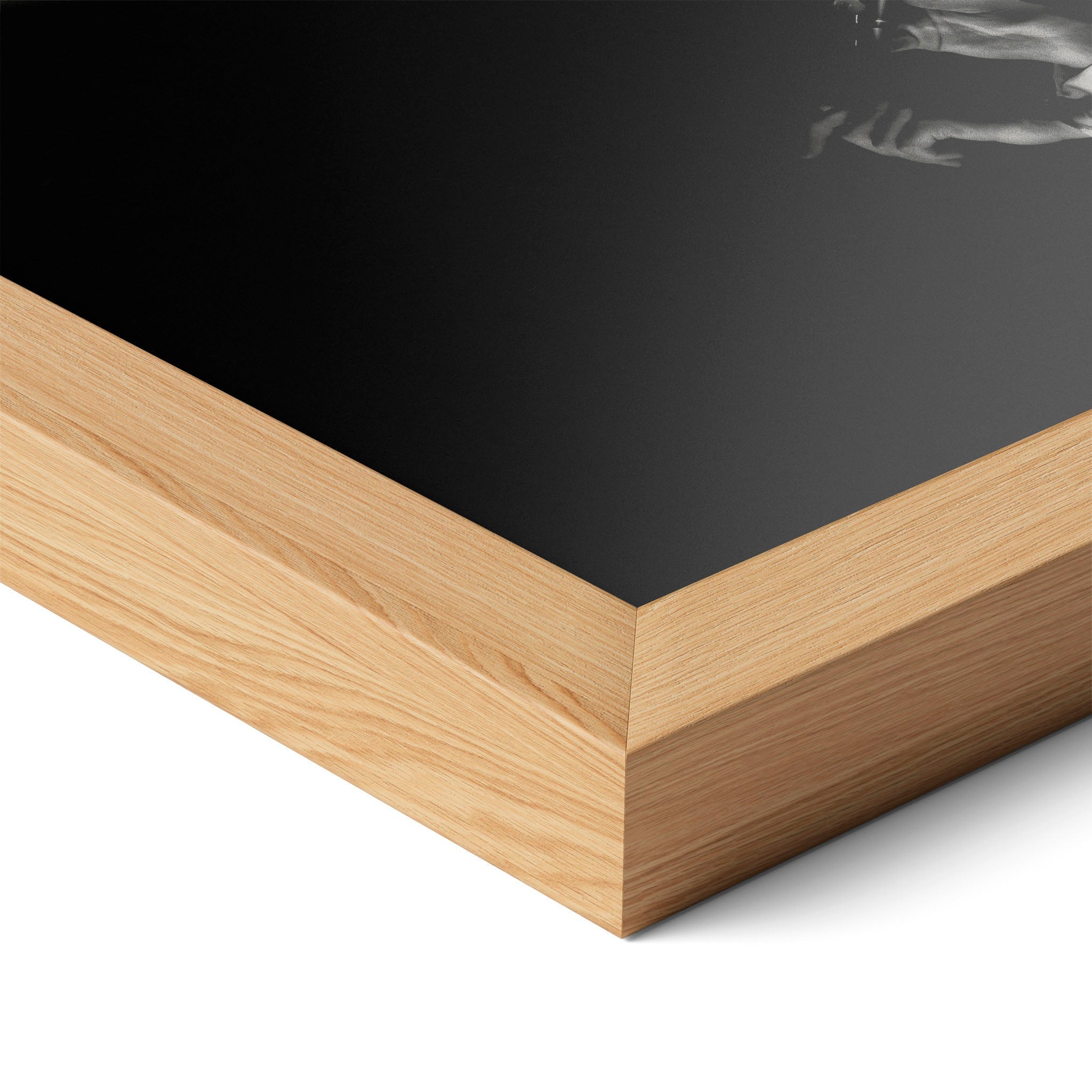Corner close-up highlighting the natural oak finish of the framed David Bowie 1976 black and white poster.