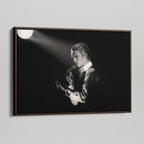 Angled view of the David Bowie 1976 black and white canvas in a sophisticated dark walnut floating frame.