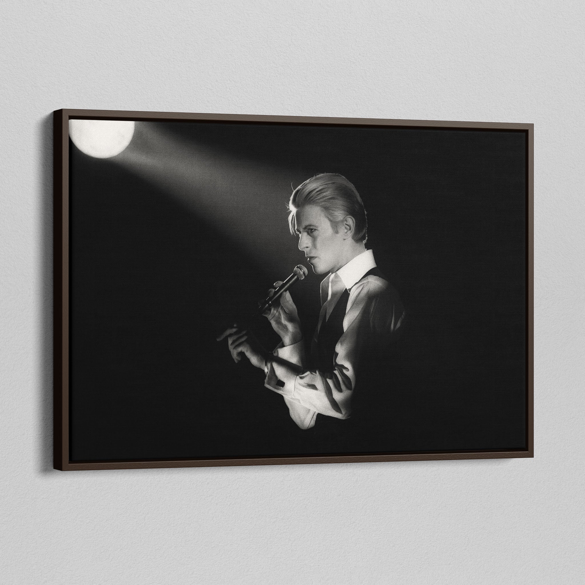 Angled view of the David Bowie 1976 black and white canvas in a sophisticated dark walnut floating frame.