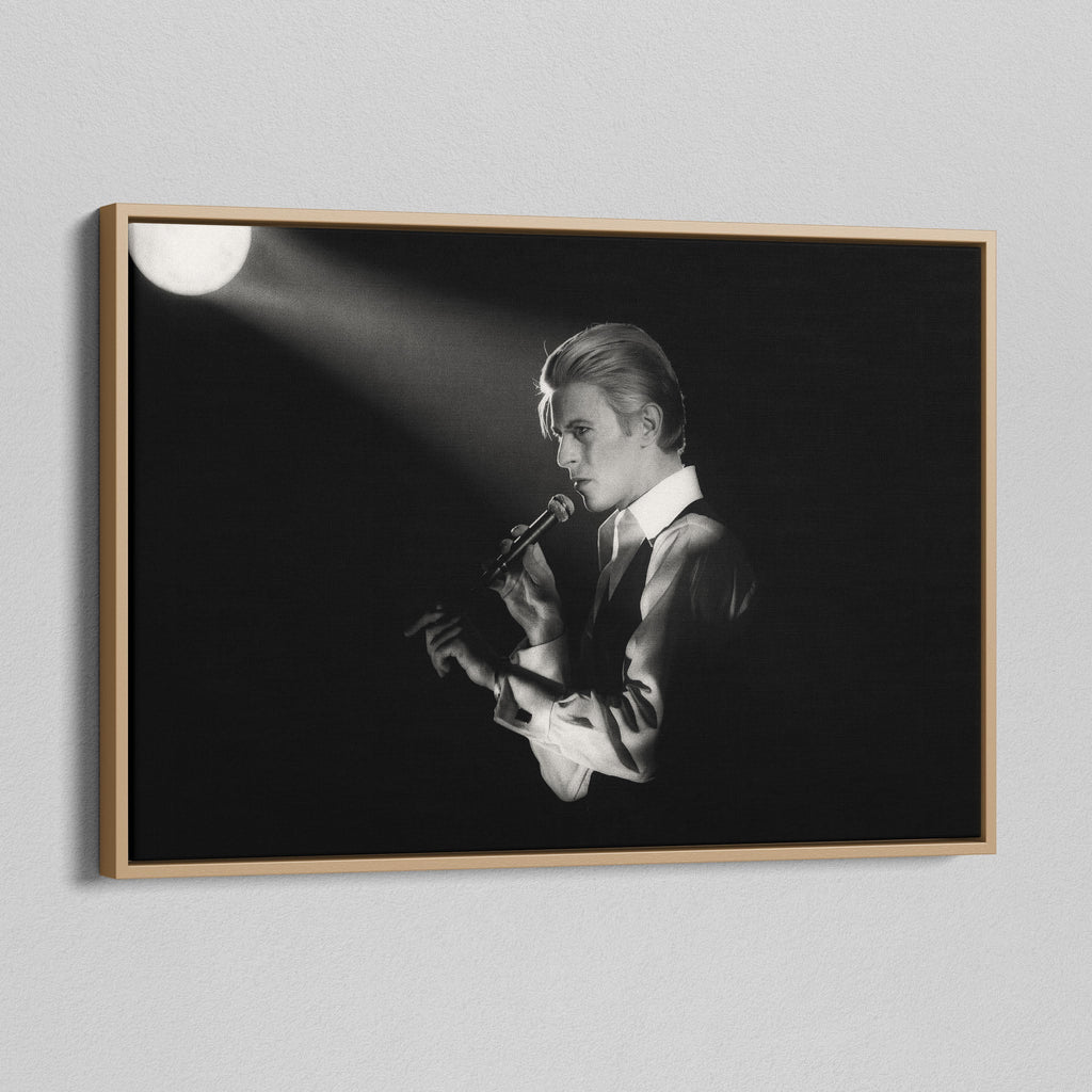 Angled view of the black and white canvas in a modern natural oak wood floating frame.