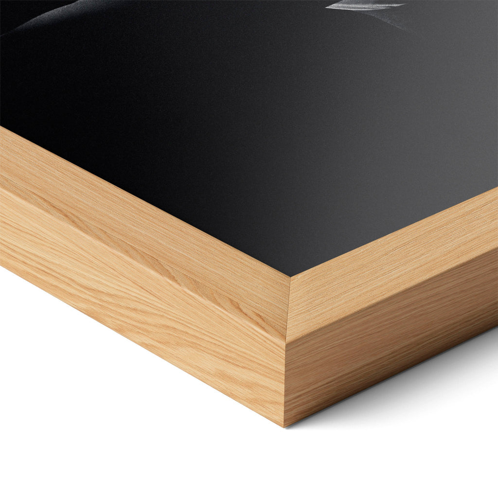 Corner close-up highlighting the natural oak finish of the framed David Bowie 1976 black and white poster.
