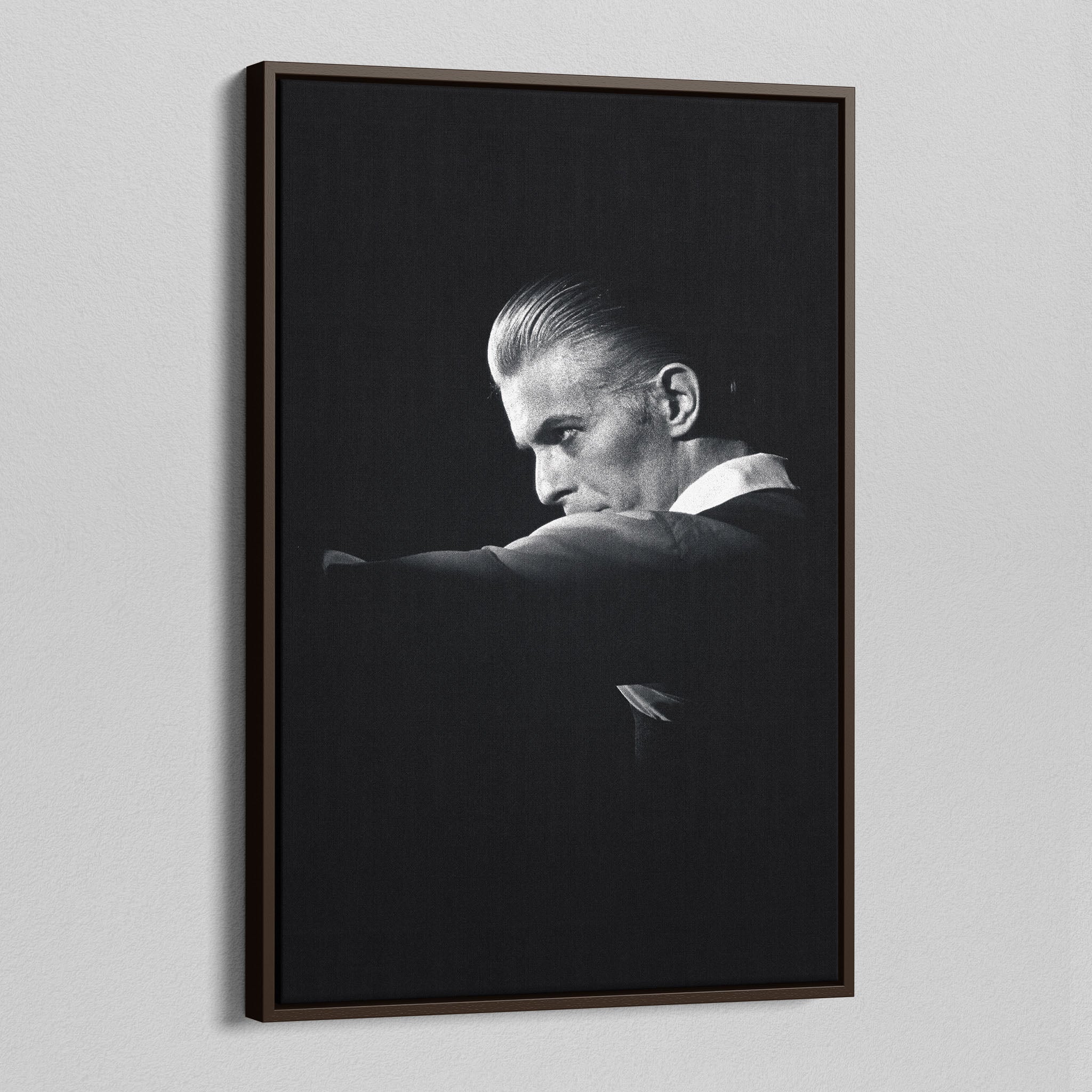 Angled view of the David Bowie 1976 black and white canvas in a sophisticated dark walnut floating frame.