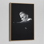 Angled view of the black and white canvas in a modern natural oak wood floating frame.