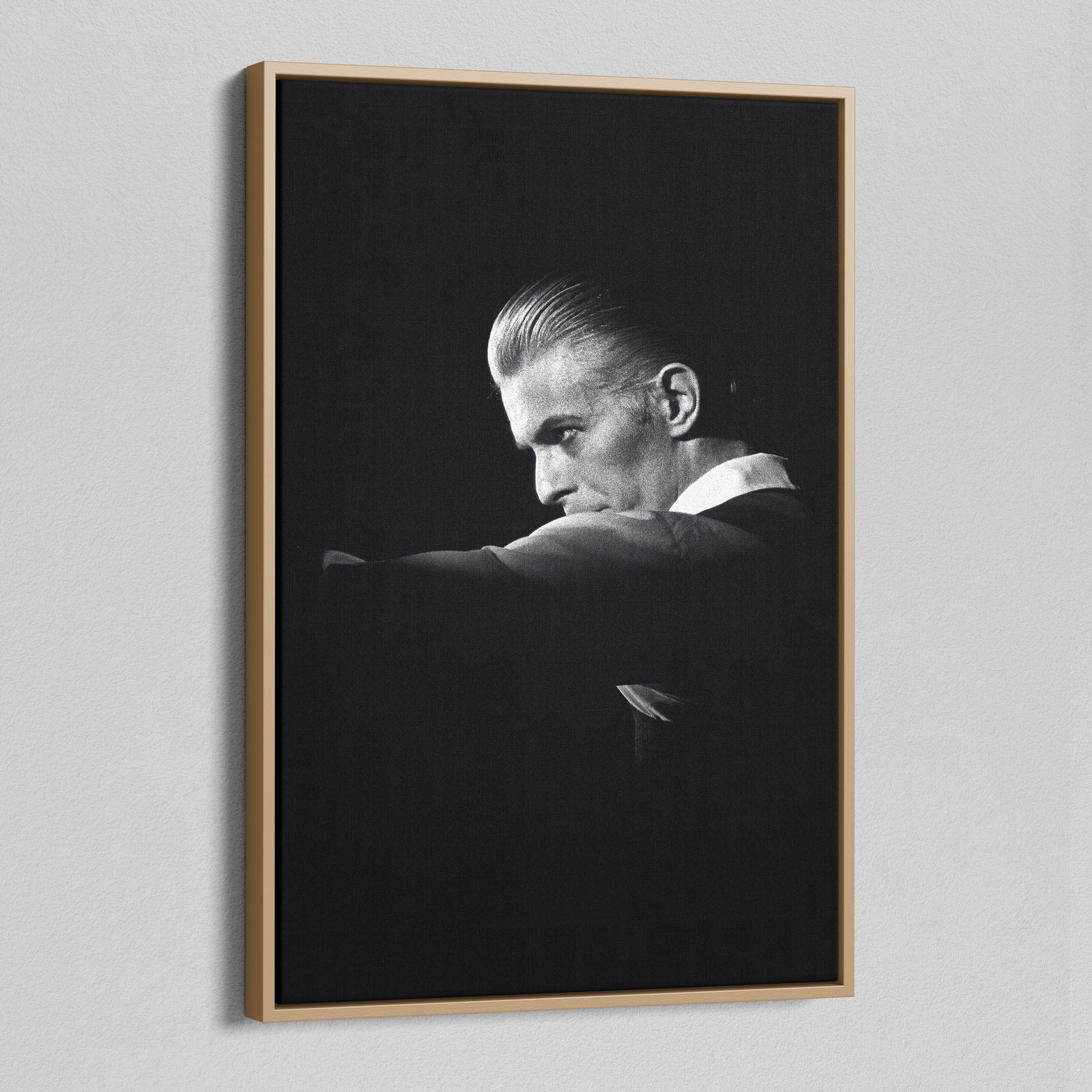 Angled view of the black and white canvas in a modern natural oak wood floating frame.