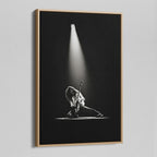 Angled view of the black and white canvas in a modern natural oak wood floating frame.