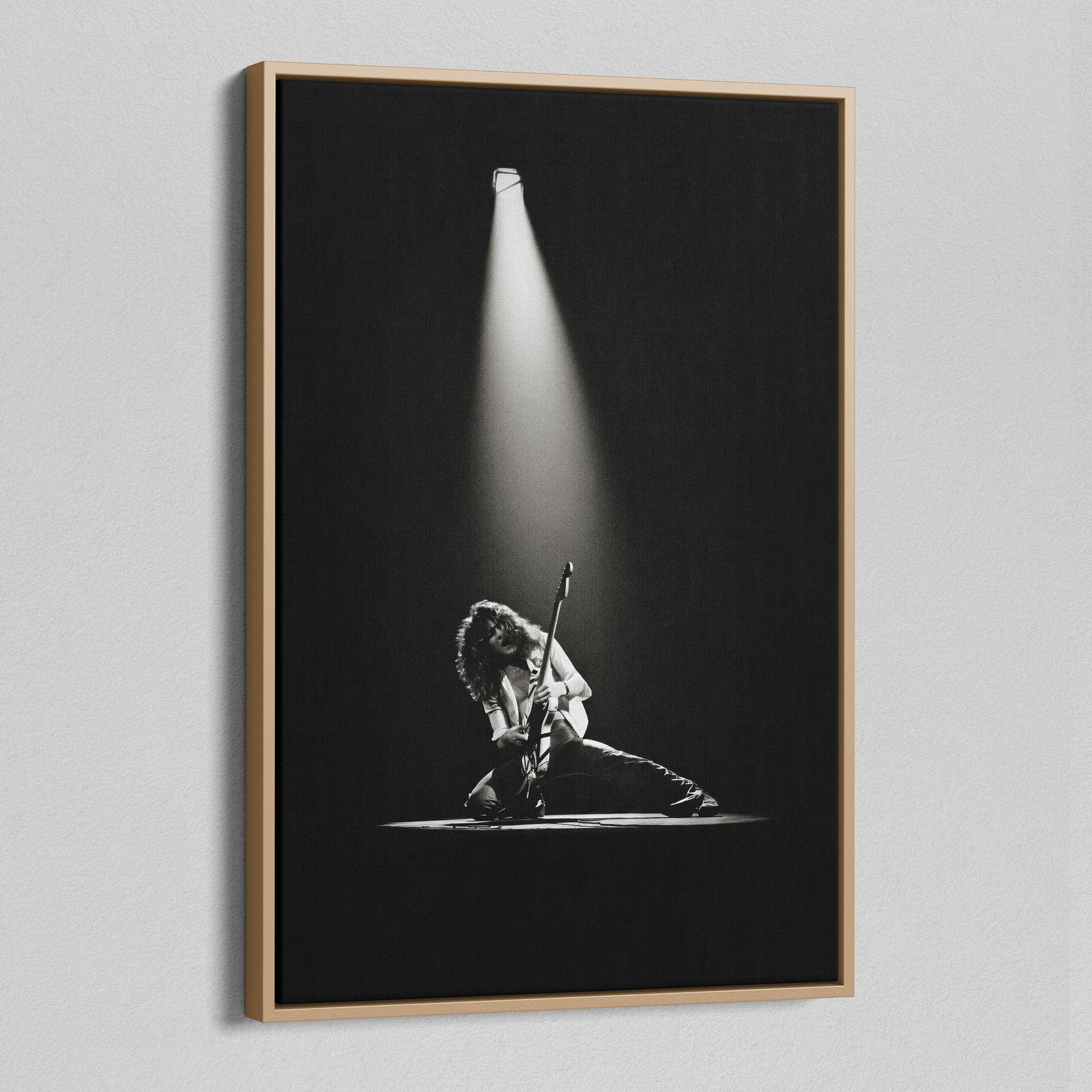 Angled view of the black and white canvas in a modern natural oak wood floating frame.