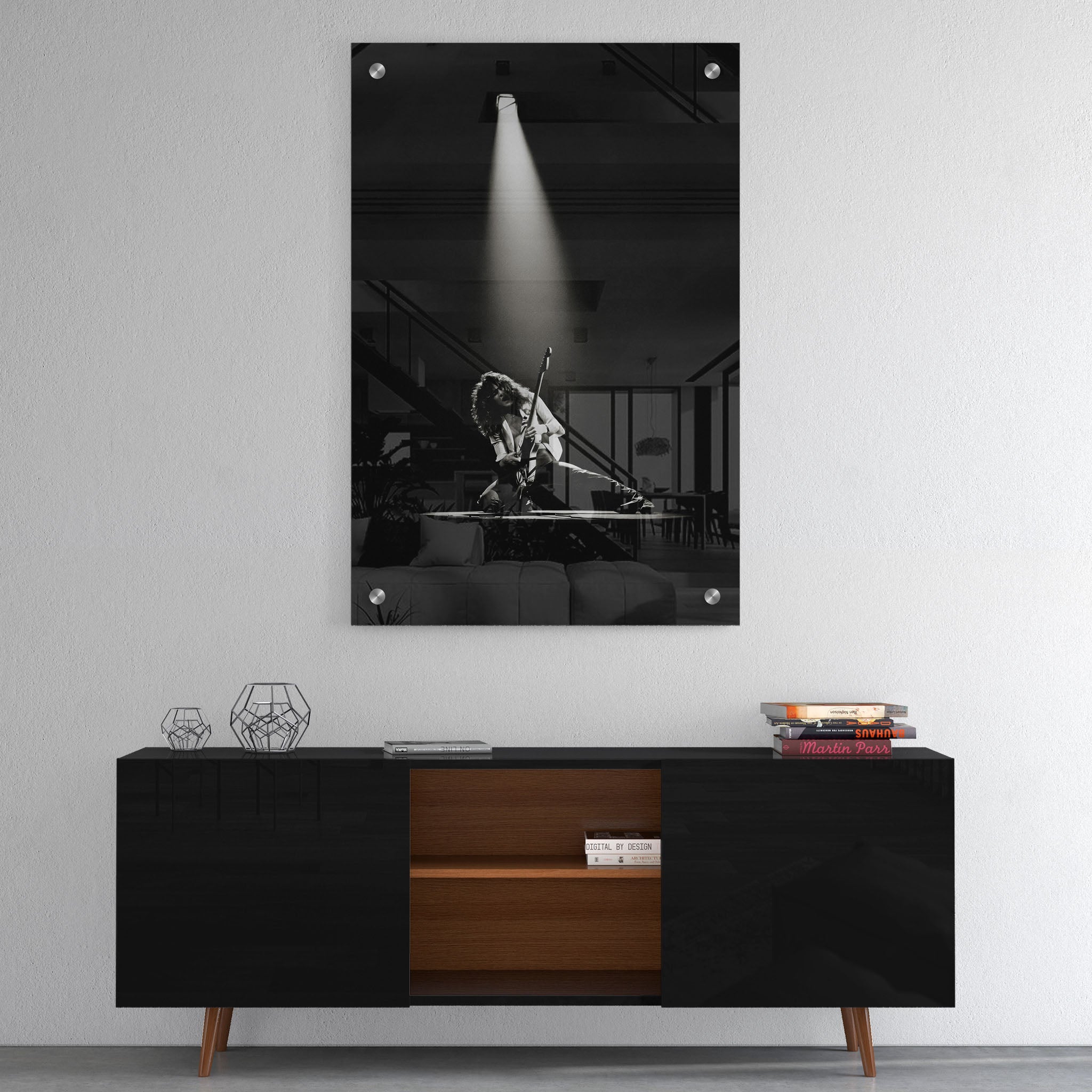 High-gloss acrylic glass black and white print of Eddie Van Halen displayed above a contemporary console.