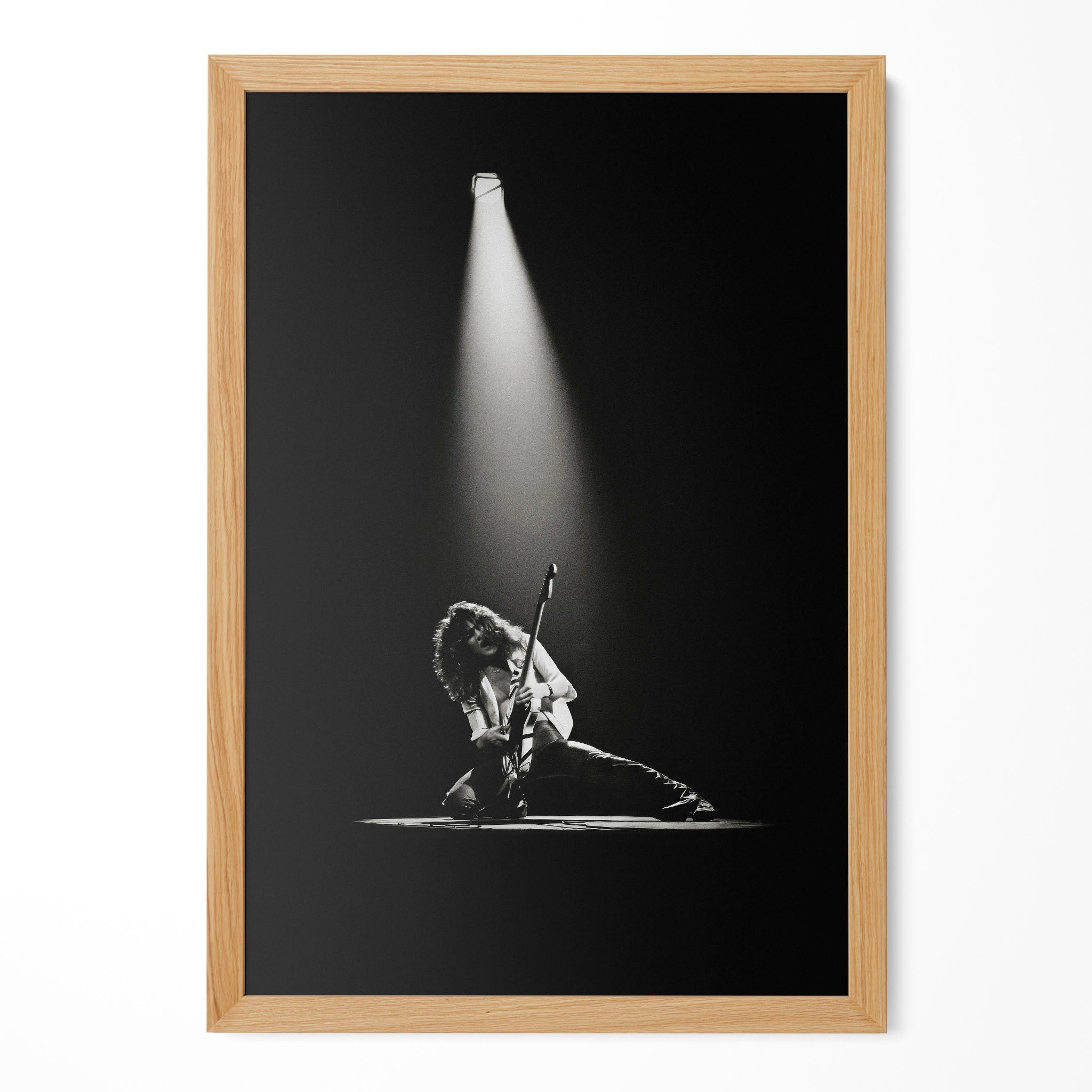Eddie Van Halen 1978 live black and white guitar poster in a premium natural oak wood frame by POSTEREVER.