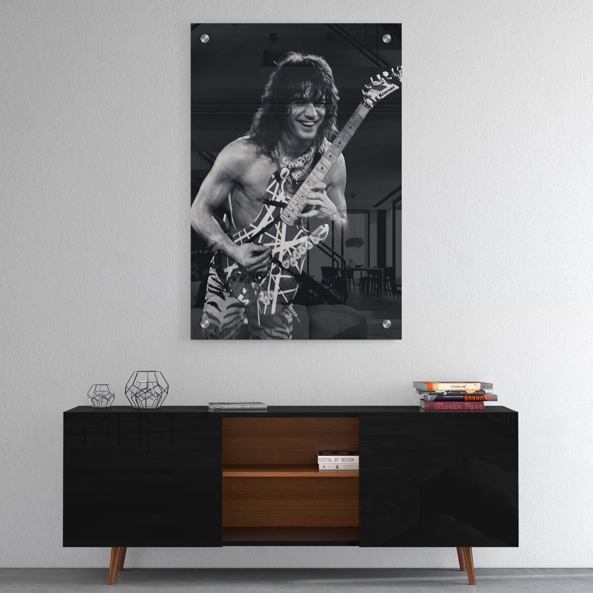 High-gloss acrylic glass black and white print of Eddie Van Halen displayed above a contemporary console.