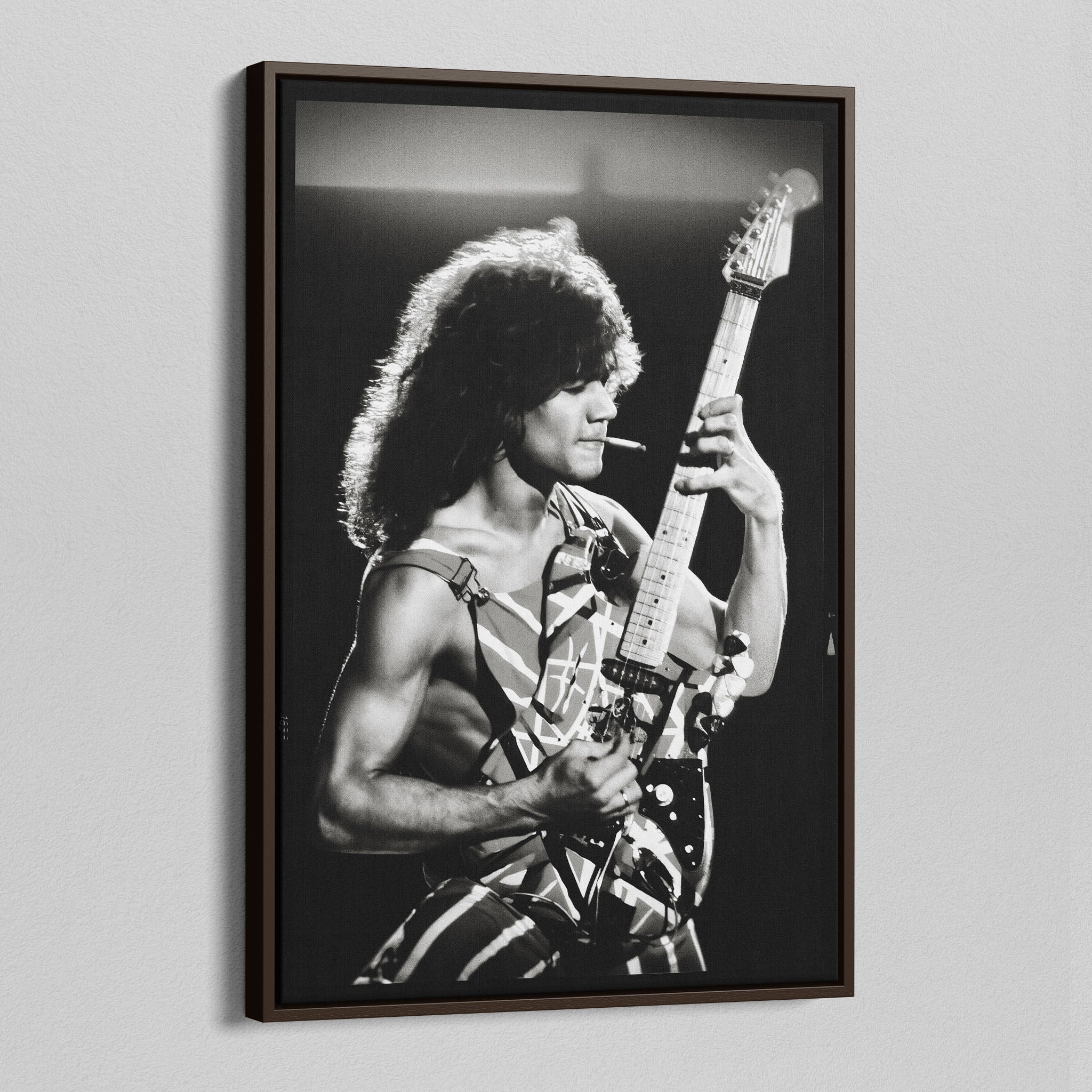 Angled view of the Eddie Van Halen black and white canvas in a sophisticated dark walnut floating frame.