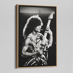 Angled view of the black and white canvas in a modern natural oak wood floating frame.