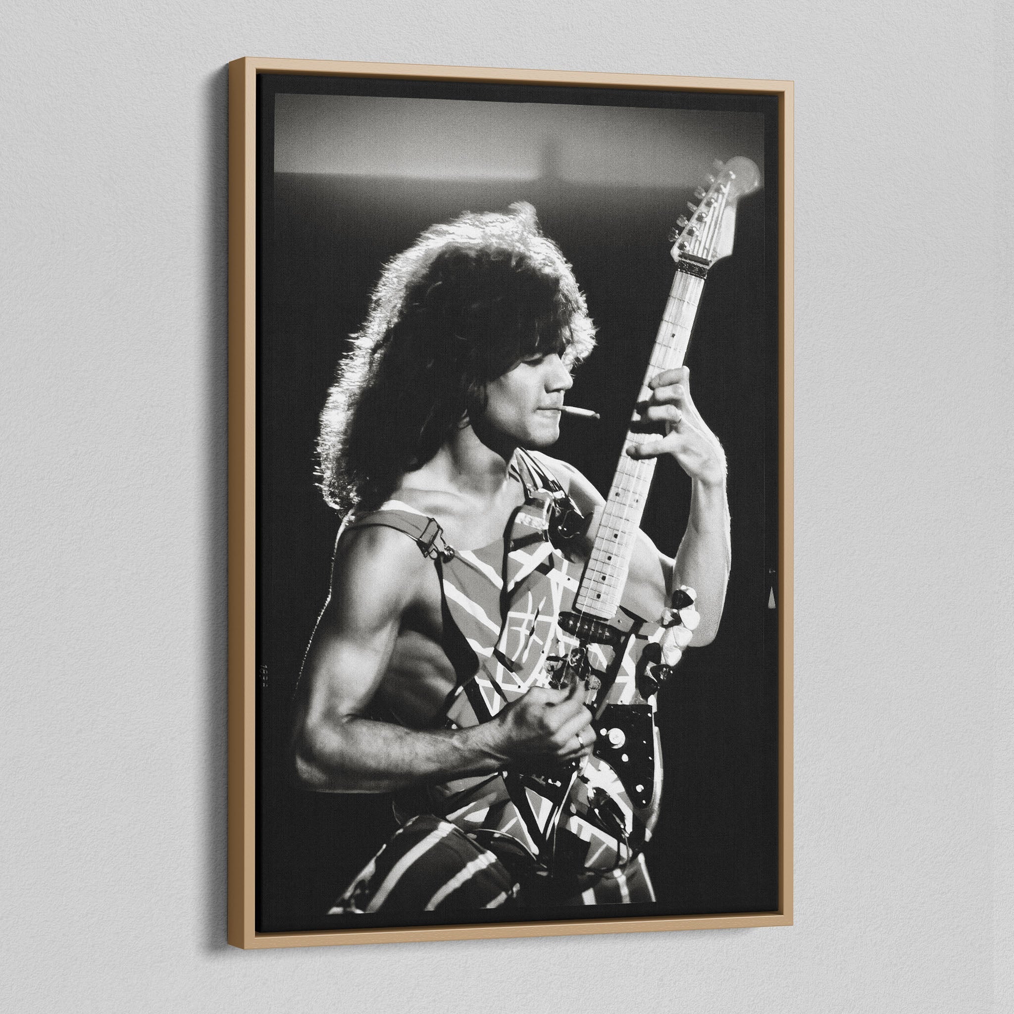 Angled view of the black and white canvas in a modern natural oak wood floating frame.